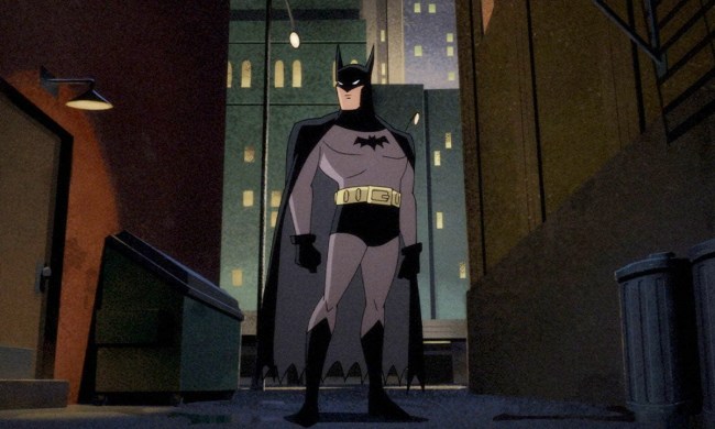 Batman stands in a dark alley in Batman: Caped Crusader.