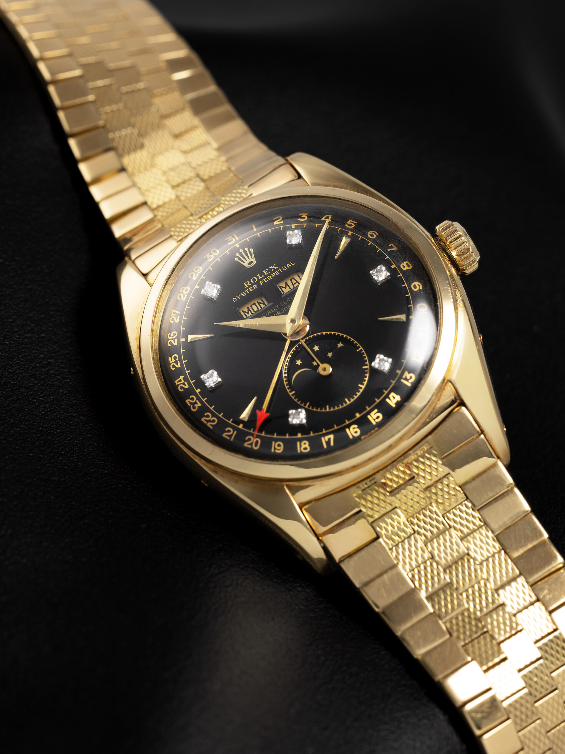 Rolex 6062 yellow gold watch with black lacquer dial and diamond hour markers on tile bracelet