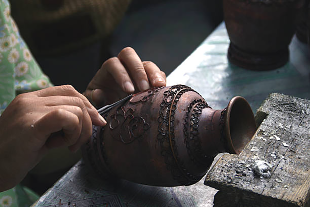 Applying fine wires to form outlines for decoration, credit: Istockphoto